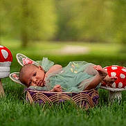 Ah'Laysha joined the competition — help win amazing prizes! baby, infant, bunny_ears, basket, green_dress, grass, mushroom_stools, outdoor, nature, polka_dots, cute, lying_down, fairy_tale, child, portrait, soft_focus, whimsical, spring, garden, newborn