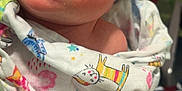 Caiden is registered to the contest to win money with this photo: baby, infant, blanket, colorful, pattern, animal_print, cast, arm, close_up, face, skin, eyes, indoor, soft_lighting, curious, child, newborn, wrapped, gaze, person
