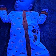 Caiden is registered to the contest to win money with this photo: baby, sleeping, onesie, blue_light, infant, peaceful, face, arms, clothing, fabric, texture, lying_down, cute, child, soft, portrait, comfort, indoors, sleep, pajamas