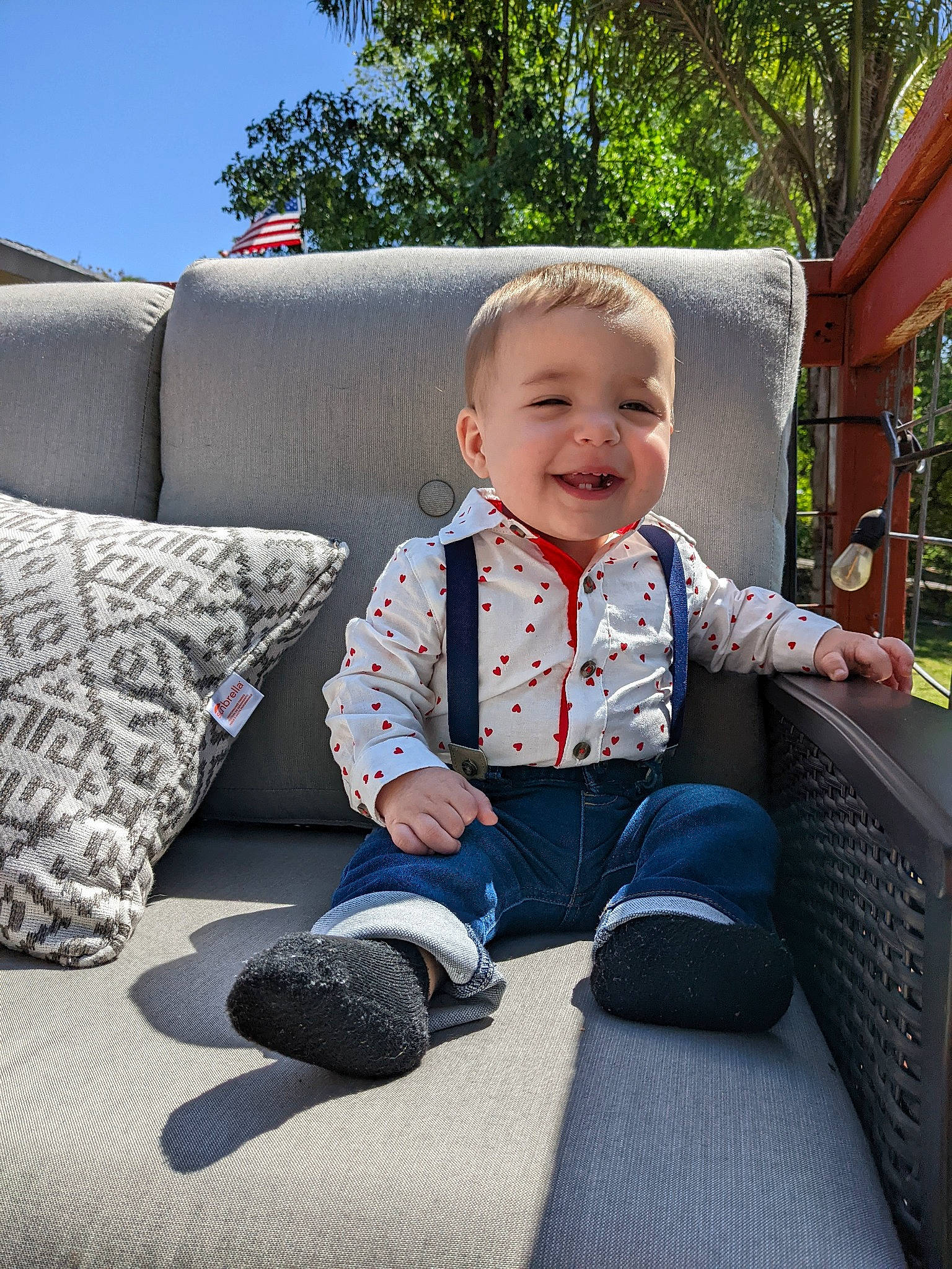Cash is registered to the contest to win money with this photo: baby, baby_toddler_clothing, child, comfort, couch, facial_expression, fun, grass, hairstyle, happy, head, home, joy, leisure, person, plant, sitting, sky, smile, sneakers