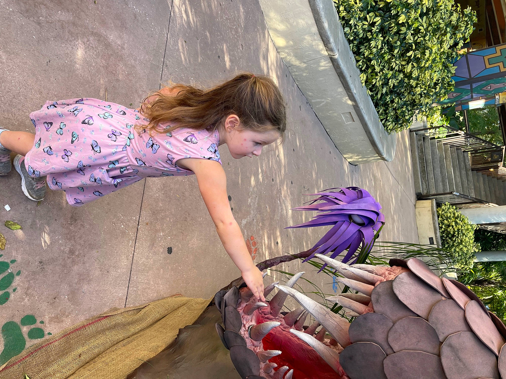 Addilynn is registered to the contest to win money with this photo: electric_blue, fun, grass, human_leg, leisure, light, magenta, people, person, pink, plant, purple, sitting, sneakers, soil, spring, summer, textile, thigh, toddler