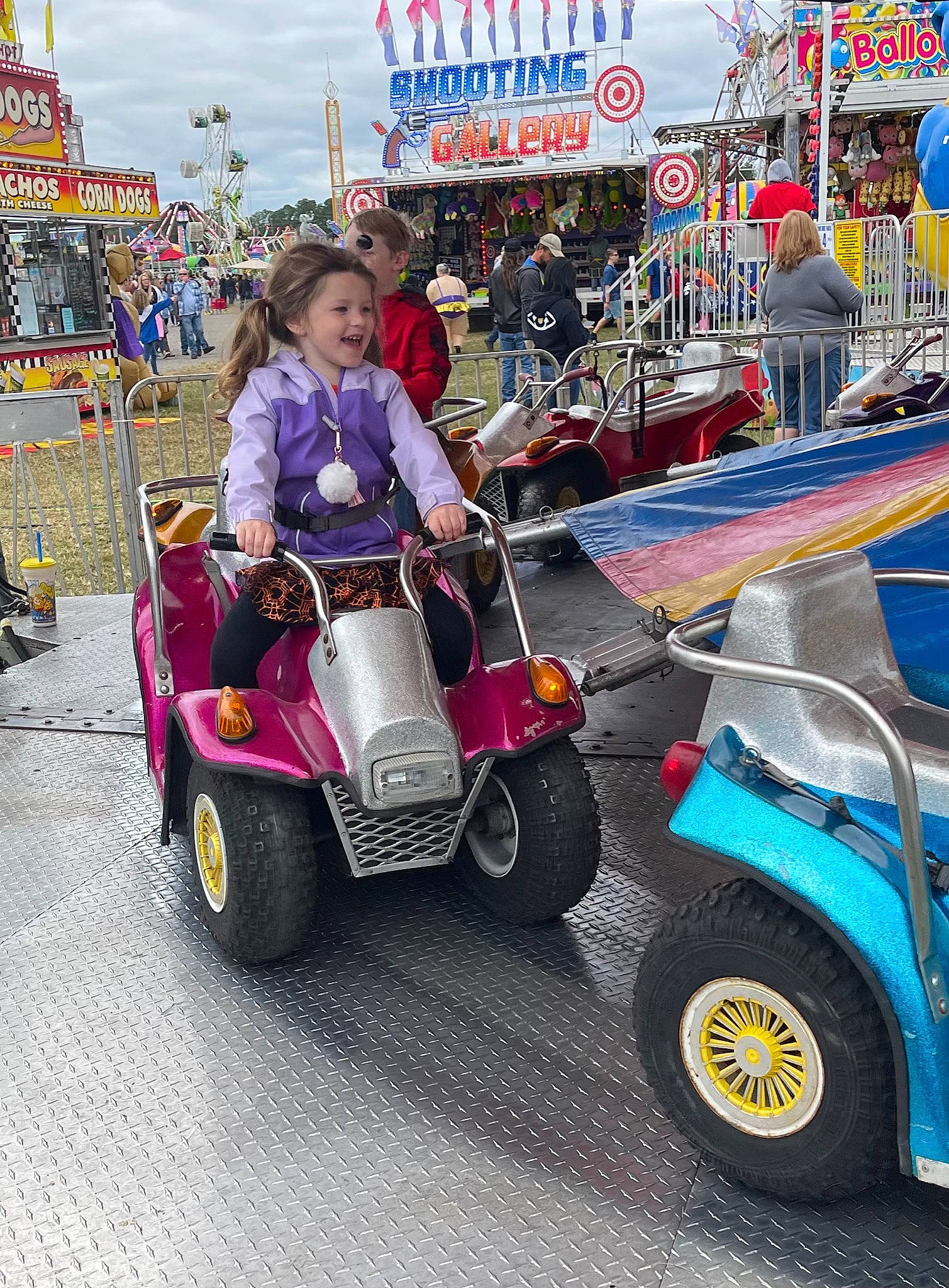 Addilynn joined the competition — help win amazing prizes! auto_part, automotive_design, automotive_exterior, automotive_tire, automotive_wheel_system, car, classic, event, fun, joy, leisure, mode_of_transport, motor_vehicle, person, purple, recreation, riding_toy, smile, tire, travel