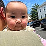 adult, baby, blue_sky, cheeks, child, clothing, cute, daylight, expression, face, happy, head, holding, infant, outdoor, parked_cars, person, portrait, shoulder, sky