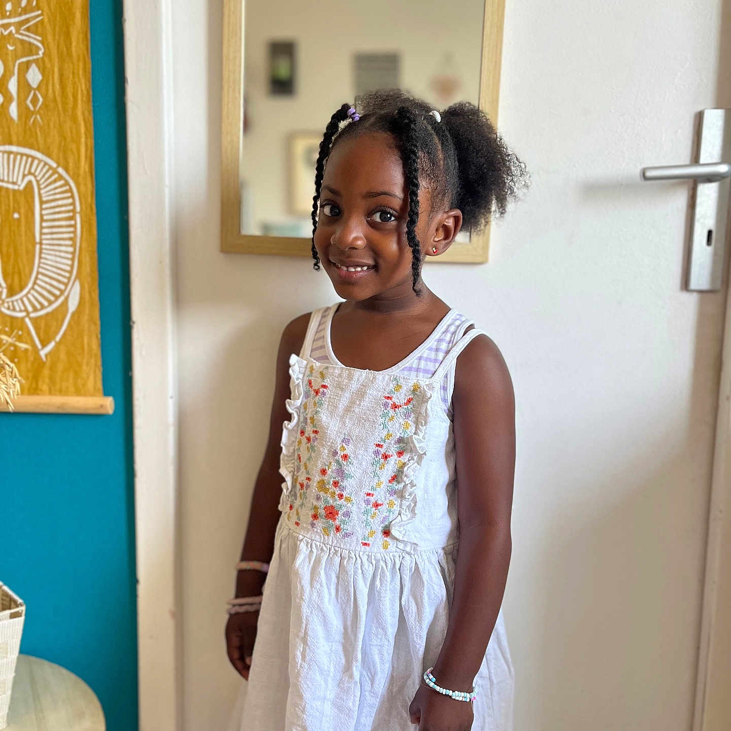 Talia participe au concours pour gagner de l'argent avec cette photo : basket, bracelet, child, curly_hair, door, dress, girl, hairstyle, happy, indoor, mirror, pigtails, portrait, room, smile, standing, table, tapestry, wall, white_dress