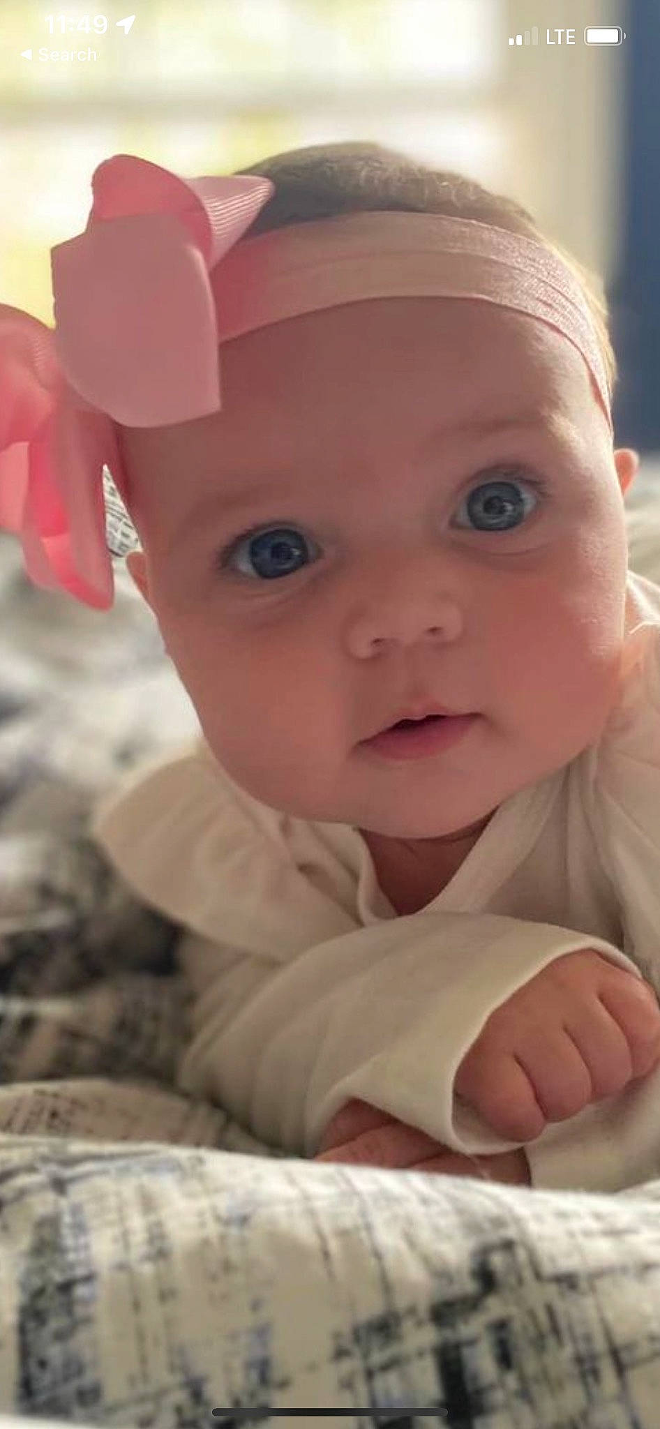 Carly is registered to the contest to win money with this photo: baby, baby_toddler_clothing, cheek, chin, comfort, dress, face, finger, gesture, happy, hat, headwear, human_body, lip, mammal, mouth, nose, person, pink, skin