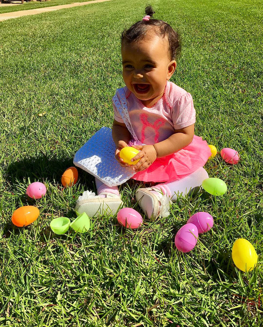 Eleanor Griffith is registered to the contest to win money with this photo: child, easter, easter_egg, egg, flower, games, grass, grass_family, happy, holiday, lawn, people_in_nature, person, plant, play, sitting, spring, toddler