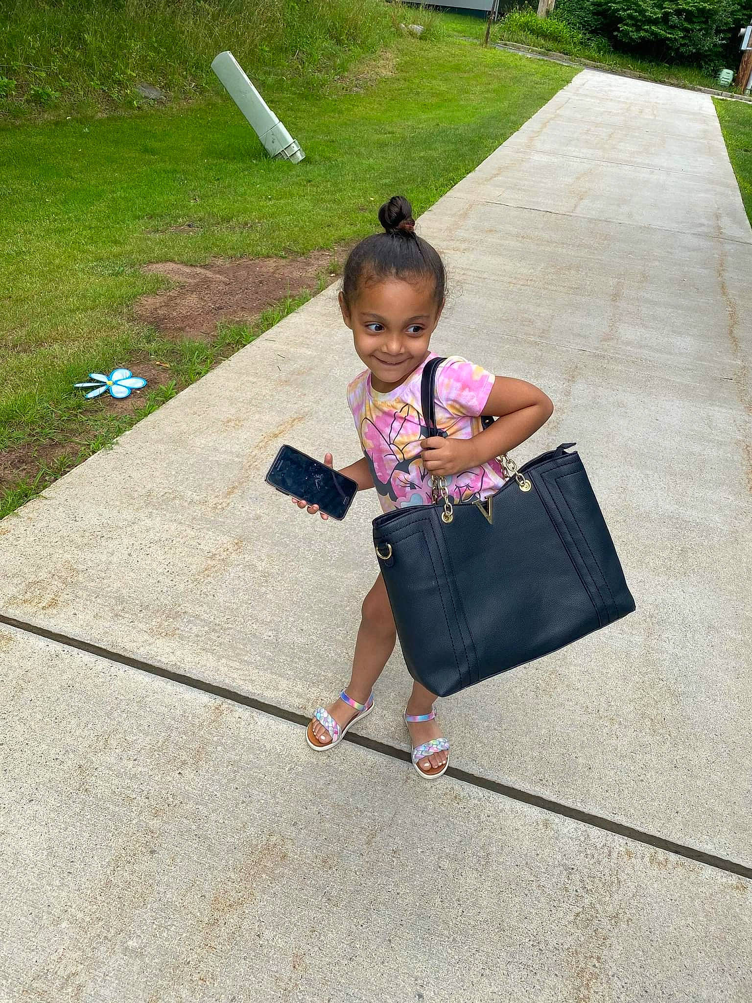 Gabby joined the competition — help win amazing prizes! asphalt, baby_toddler_clothing, bag, baggage, box, child, fun, grass, joy, leisure, luggage_and_bags, magenta, pattern, person, plant, play, recreation, road_surface, sidewalk, sitting