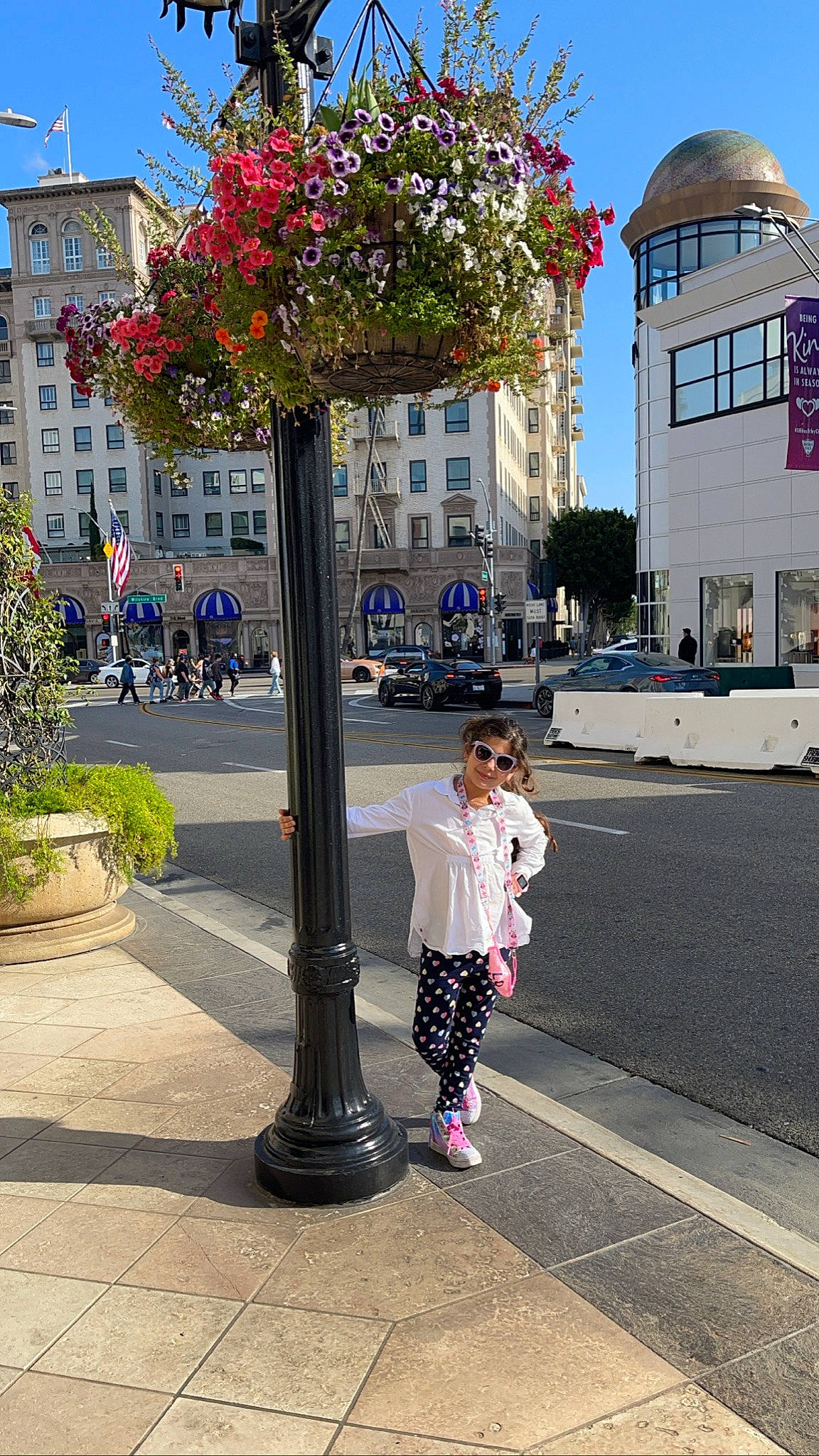 Dania is registered to the contest to win money with this photo: architecture, building, flower, infrastructure, joy, leaf, leisure, line, morning, people, person, plant, road, road_surface, sidewalk, sky, summer, travel, urban_design, wheel