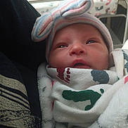 Catalina is registered to the contest to win money with this photo: newborn, baby, blanket, hat, bow, person, infant, clothing, face, headwear, wrapped, cozy, indoor, cute, portrait, child, soft, warm, closeup, sleepy