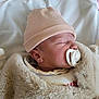 baby, bed, blanket, child, closeup, cozy, cute, fur, hat, indoor, infant, newborn, pacifier, peaceful, portrait, resting, sleeping, soft, warm, wrapped