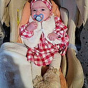 Jeanne participe au concours pour gagner de l'argent avec cette photo : baby, blanket, car_seat, cute, eyes, face, faux_fur_vest, fuzzy_booties, hands, headband, indoor, infant, legs, pacifier, plaid_dress, portrait, safety_label, soft_lighting, stroller, tiled_floor
