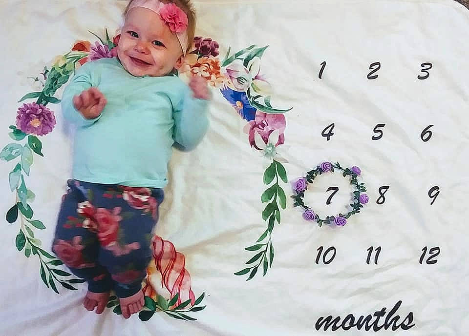 Lyla is registered to the contest to win money with this photo: baby, baby_toddler_clothing, craft, creative_arts, cut_flowers, embellishment, embroidery, floral_design, hair_accessory, headwear, home_accessories, joy, lavender, linens, pattern, person, petal, pink, rose, textile