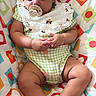 baby, bib, child, clothing, colorful, cute, green, hands, indoors, infant, legs, orange, pacifier, patterned_cushion, peaceful, red, resting, sleeping, soft_lighting, white