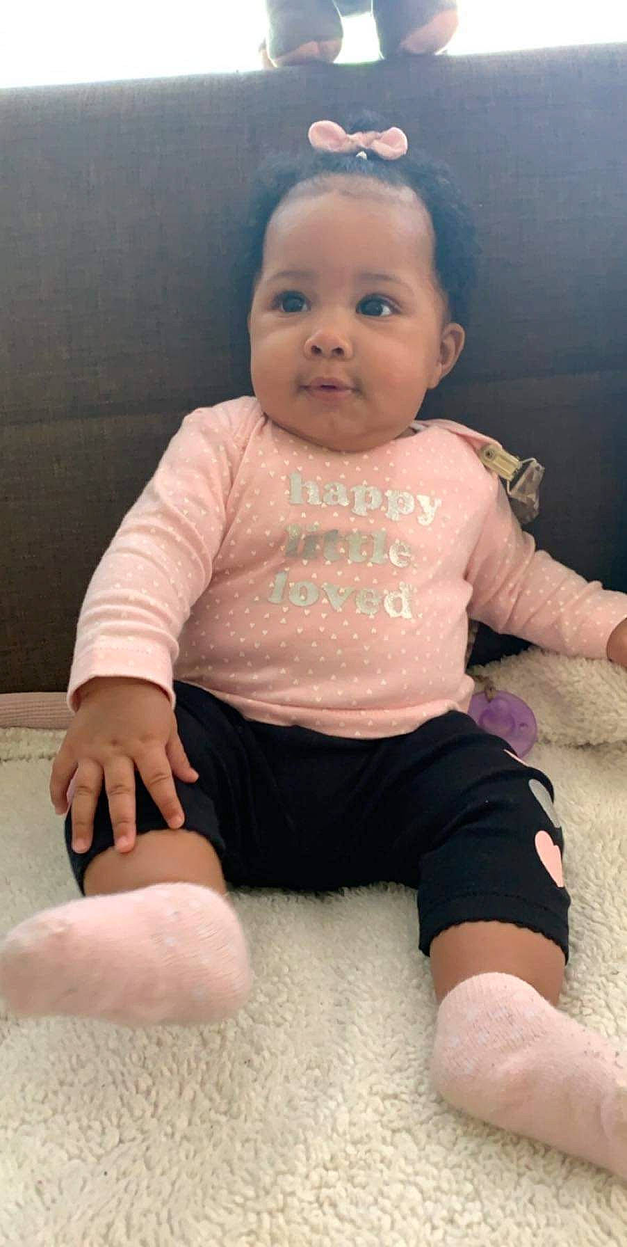 Kimari is registered to the contest to win money with this photo: arm, baby, baby_toddler_clothing, cheek, child, face, finger, head, leg, person, sitting, skin, sleeve, thumb, toddler