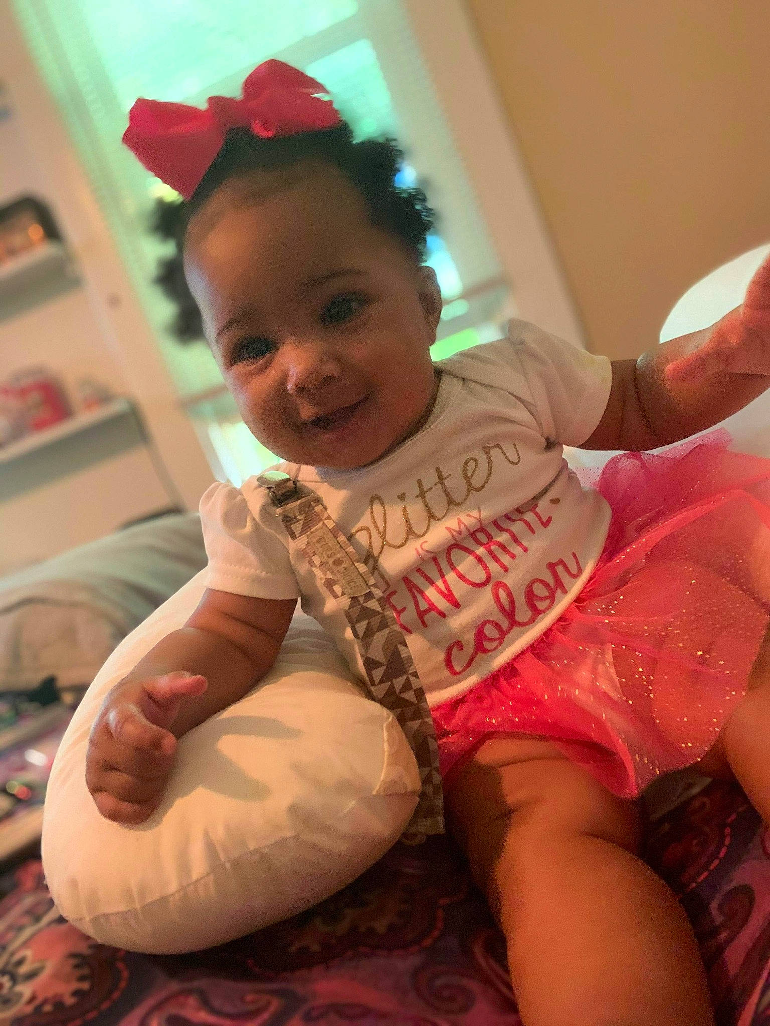 Kimari is registered to the contest to win money with this photo: arm, baby, child, finger, fun, happy, person, pink, play, sitting, skin, smile, thumb, toddler