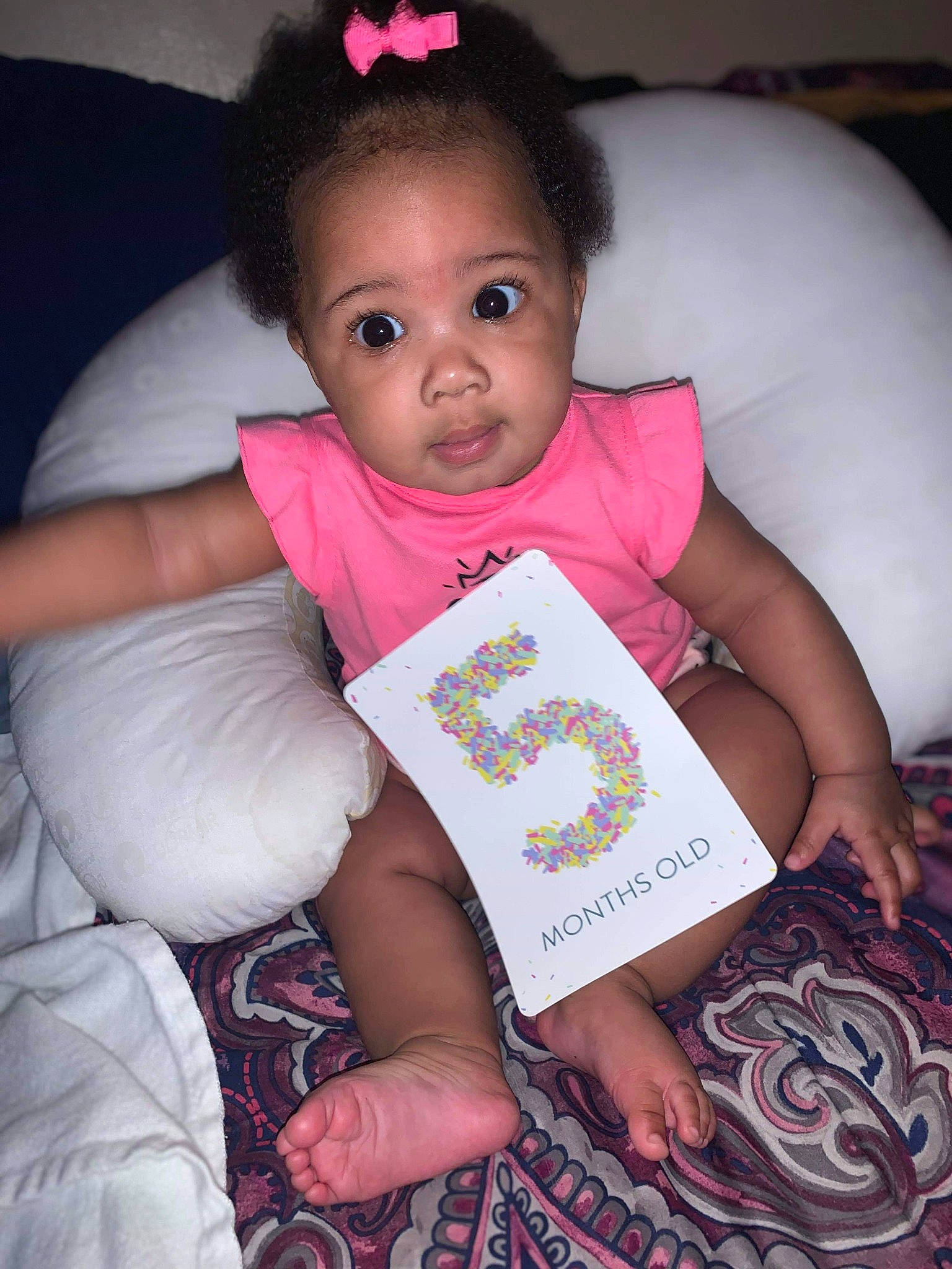Kimari is registered to the contest to win money with this photo: baby, baby_toddler_clothing, bedtime, child, person, pink, reading, sitting, skin, smile, toddler