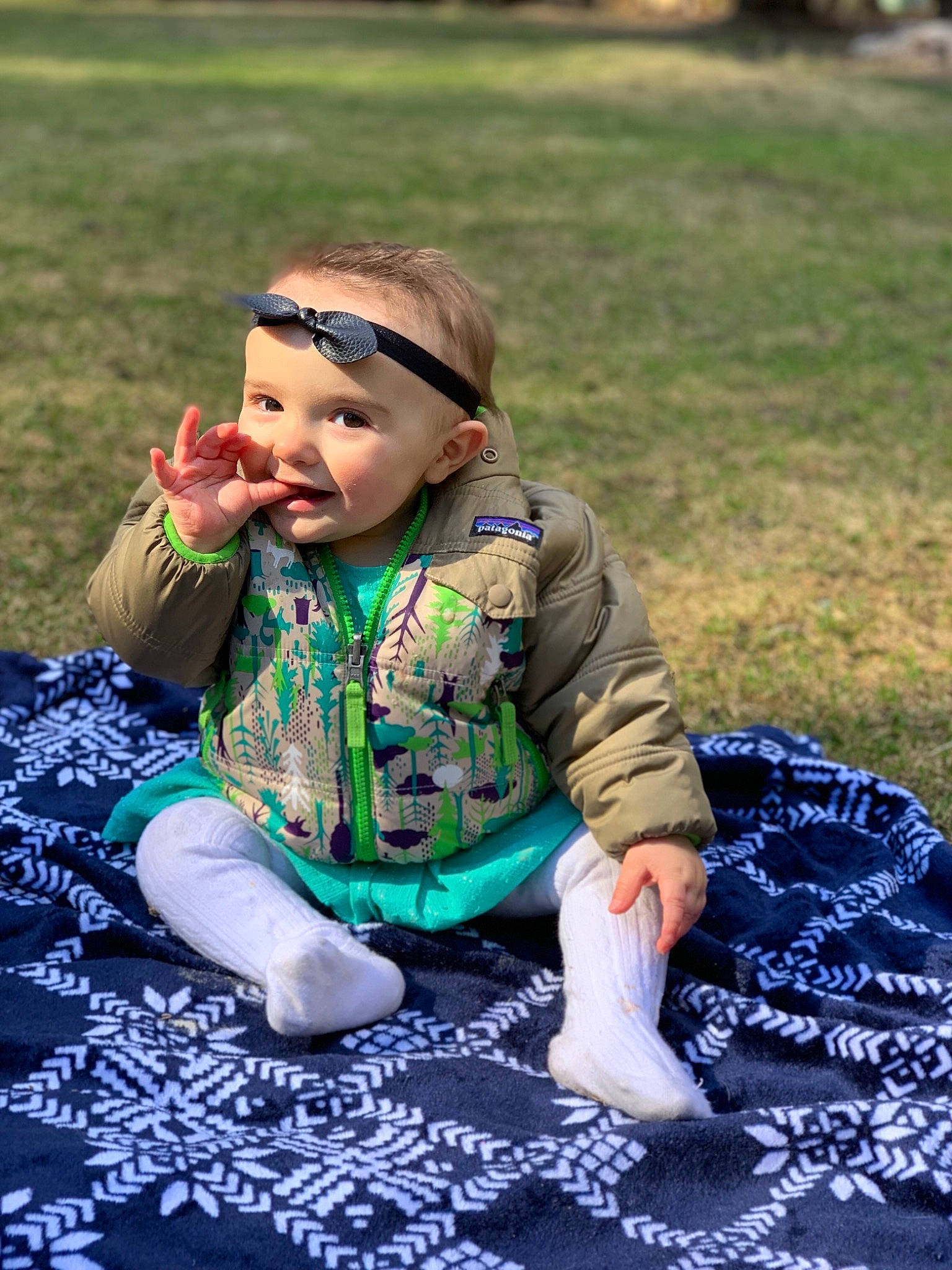 Dally is registered to the contest to win money with this photo: adaptation, baby, cheek, child, fun, grass, green, headwear, joy, lawn, leaf, pattern, people, person, plant, play, sitting, smile, toddler, vacation