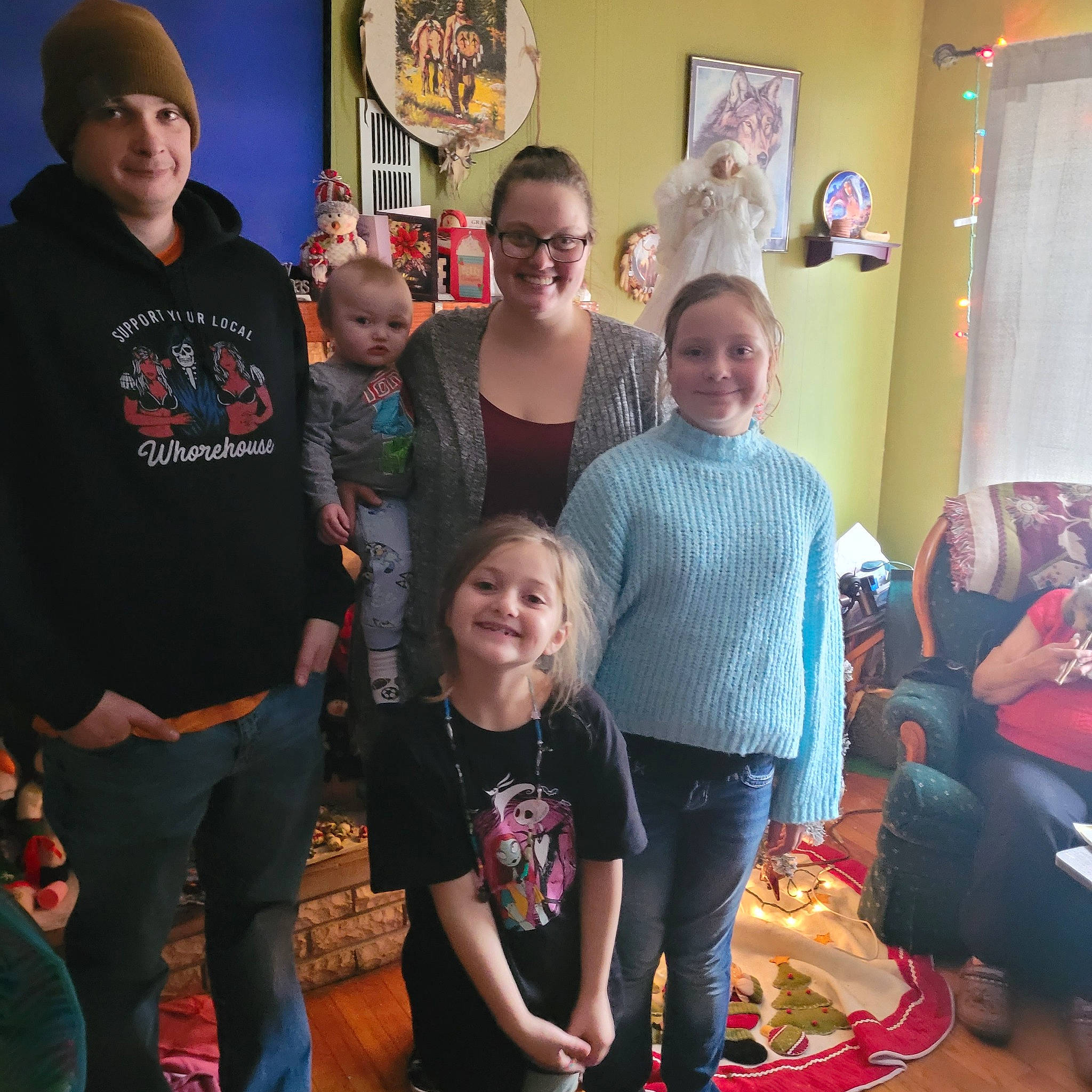 Lexi joined the competition — help win amazing prizes! baseball_cap, cap, child, community, couch, event, fun, happy, hat, headwear, holiday, joy, lap, living_room, person, picture_frame, room, smile, standing, t_shirt