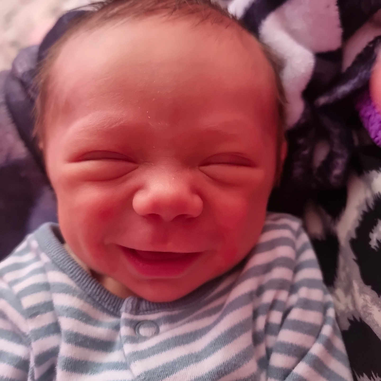 Brodie joined the competition — help win amazing prizes! baby, child, closeup, cute, face, happy, head, indoors, infant, newborn, onesie, person, portrait, resting, skin, sleepy, smile, soft_blanket, striped_clothing, young_child