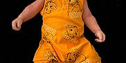 Elijah is registered to the contest to win money with this photo: baby, infant, child, person, yellow_clothing, simba, disney, onesie, socks, white_socks, black_background, portrait, cute, lying_down, baby_garment, newborn, face, head, arms, legs