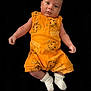 baby, infant, child, person, yellow_clothing, simba, disney, onesie, socks, white_socks, black_background, portrait, cute, lying_down, baby_garment, newborn, face, head, arms, legs