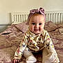 baby, bed, bedspread, bow, butterfly, child, childhood, clothing, cute, happy, headband, indoor, infant, pattern, person, portrait, sitting, smiling, toddler, young