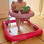 Georgia is registered to the contest to win money with this photo: baby, cabinet, child, clothing, colorful, floor, happy, headband, indoor, infant, kitchen, light, person, pink, play, smiling, standing, tile, toy, walker
