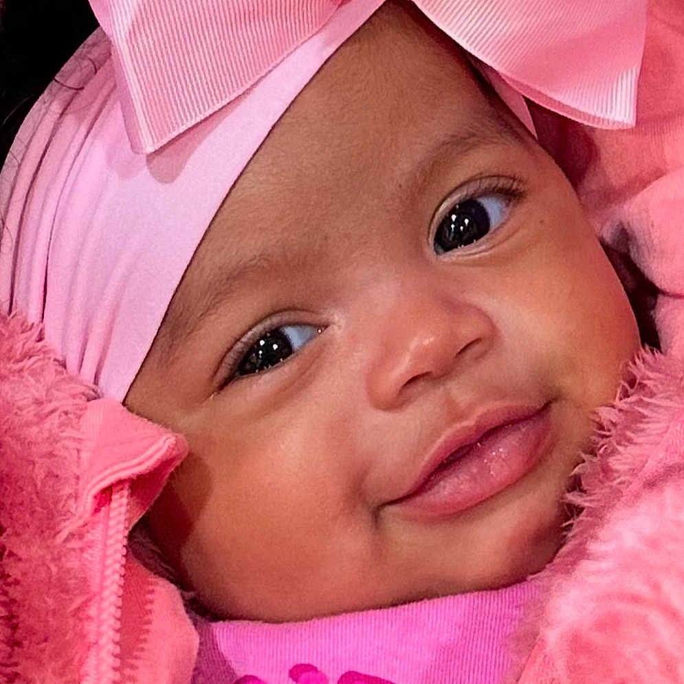 Trenity joined the competition — help win amazing prizes! baby, bonnet, cap, clothing, coat, face, happy, hat, head, hood, hoodie, jacket, knitwear, newborn, person, photography, portrait, purple, smile, sweater