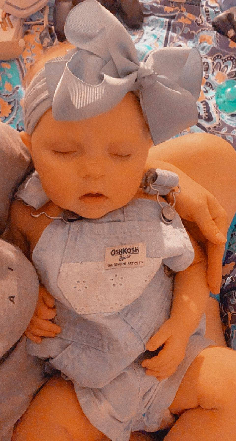 Anniston is registered to the contest to win money with this photo: arm, baby, baby_sleeping, baby_toddler_clothing, cap, cheek, chest, child, chin, eye, eyelash, finger, happy, head, headwear, human_body, mouth, orange, person, skin