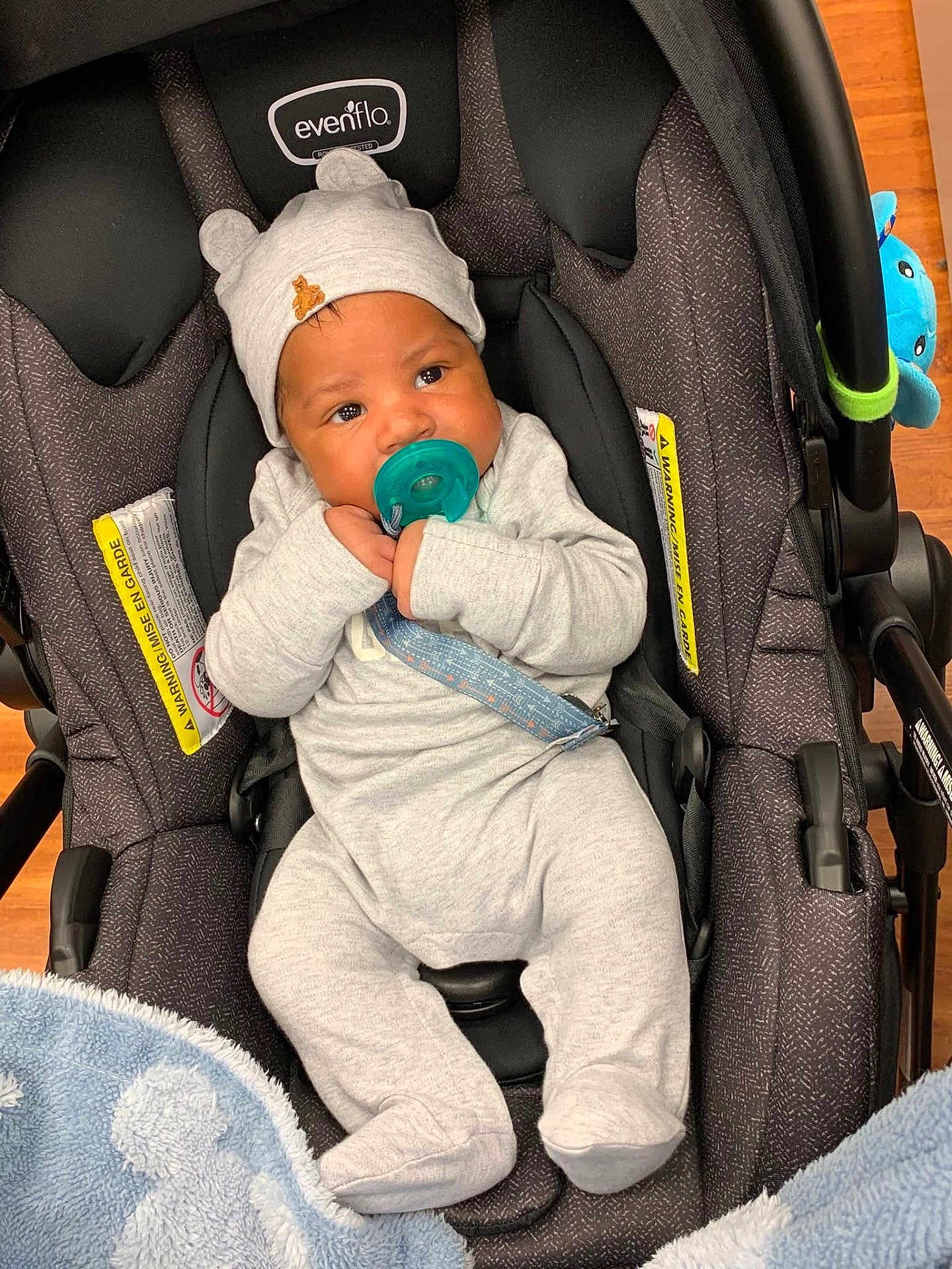 Jalynx is registered to the contest to win money with this photo: baby, infant, car_seat, pacifier, hat, clothing, blanket, plush_toy, evenflo, cute, indoors, child, footed_pajamas, baby_boy, sitting, comfort, soft_toys, car_seat_strap, headwear, floor