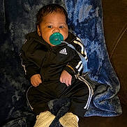 Jalynx joined the competition — help win amazing prizes! baby, child, infant, pacifier, tracksuit, adidas, black_clothing, white_shoes, blanket, blue_blanket, couch, indoor, cute, fashion, comfort, relaxed, portrait, sitting, young, person