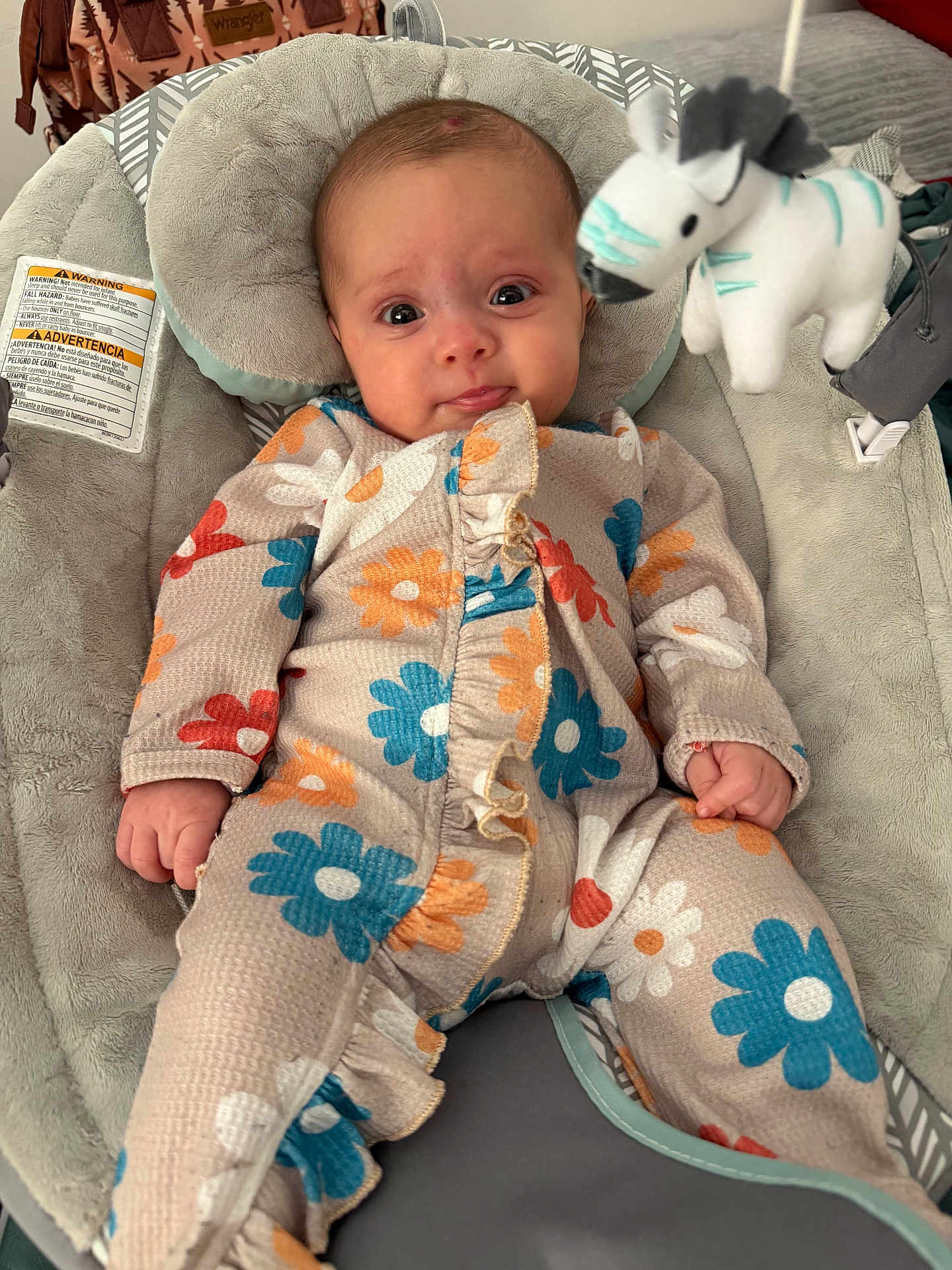 Miley joined the competition — help win amazing prizes! baby, infant, onesie, floral_pattern, baby_bouncer, stuffed_zebra, plush_toy, head_support, pillow, wide_eyes, curious_expression, hand, cozy, soft_texture, indoor, seat, safety_label, fabric, ruffle, adorable