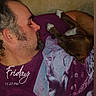 man, dog, sleeping, couch, purple_shirt, beard, piercing, snuggling, indoors, relaxing, pet, cozy, resting, casual, human, animal, comfort, face, arm, text_overlay