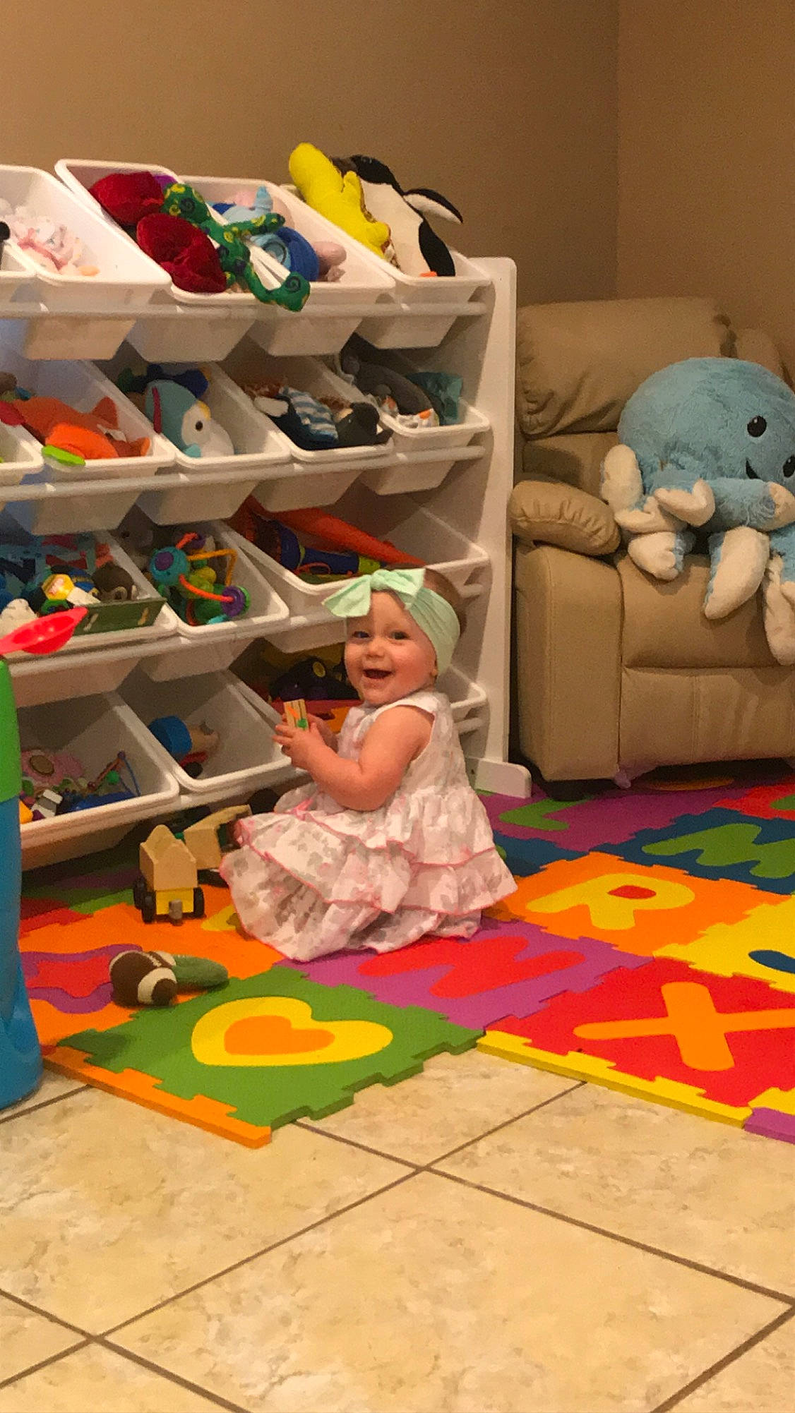 Rhea is registered to the contest to win money with this photo: child, floor, flooring, headwear, joy, kindergarten, nursery, person, play, room, toddler, toy