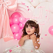 Mía Blanca joined the competition — help win amazing prizes! balloon_cluster, celebration, child, confetti, cute, decorations, event, festive, flower_headband, fringe, girl, innocence, long_hair, party, pastel, pink_balloons, portrait, smile, studio, white_dress