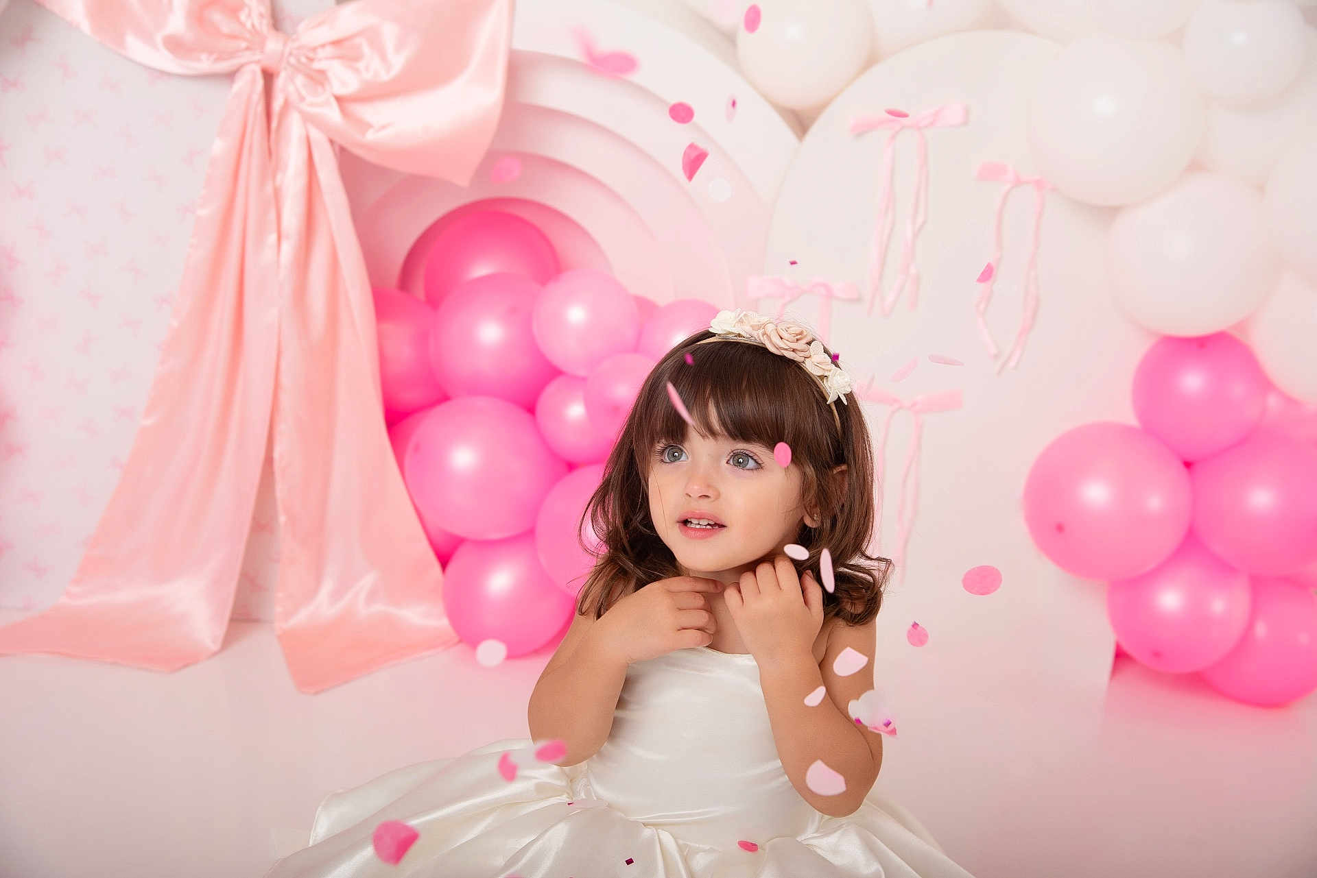 Mía Blanca joined the competition — help win amazing prizes! balloon_cluster, celebration, child, confetti, cute, decorations, event, festive, flower_headband, fringe, girl, innocence, long_hair, party, pastel, pink_balloons, portrait, smile, studio, white_dress