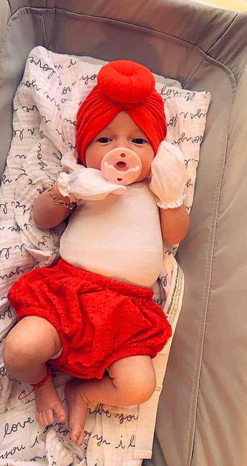 Ryder is registered to the contest to win money with this photo: abdomen, baby, baby_sleeping, baby_toddler_clothing, cap, chest, comfort, headgear, headwear, knee, linens, mouth, orange, person, pink, skin, stomach, textile, thigh, thumb