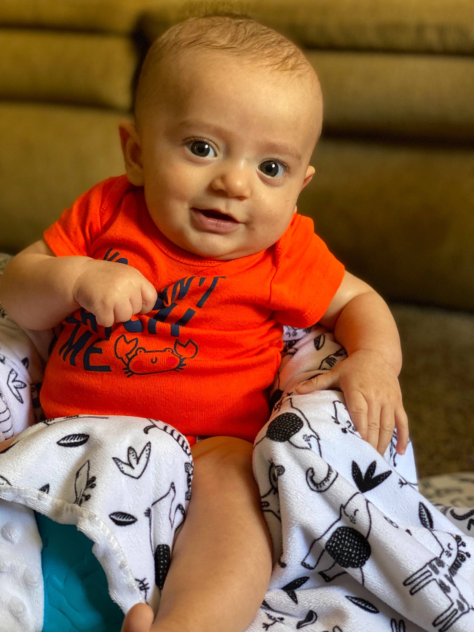 Zane is registered to the contest to win money with this photo: baby, baby_toddler_clothing, cheek, chin, comfort, eye, face, finger, happy, head, joint, muscle, orange, person, product, skin, sleeve, smile, t_shirt, toddler