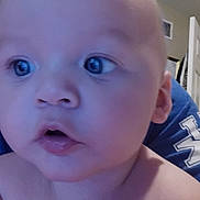 Carter joined the competition — help win amazing prizes! baby, face, head, skin, expression, indoors, person, blue_shirt, curious, closeup, child, young, portrait, human, eyeballs, lips, nose, ears, shirt, background