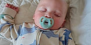 Carter joined the competition — help win amazing prizes! baby, bed, blanket, child, closed_eyes, cozy, cute, indoor, infant, nap, onesie, pacifier, pale_skin, peaceful, quilted, resting, sleeping, soft_lighting, toddler, whale_pattern