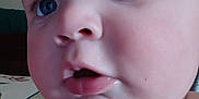 Carter is registered to the contest to win money with this photo: baby, close_up, face, blue_eyes, cheeks, child, curious, innocence, portrait, skin, expression, mouth, nose, person, young, indoors, soft_light, head, cute, human