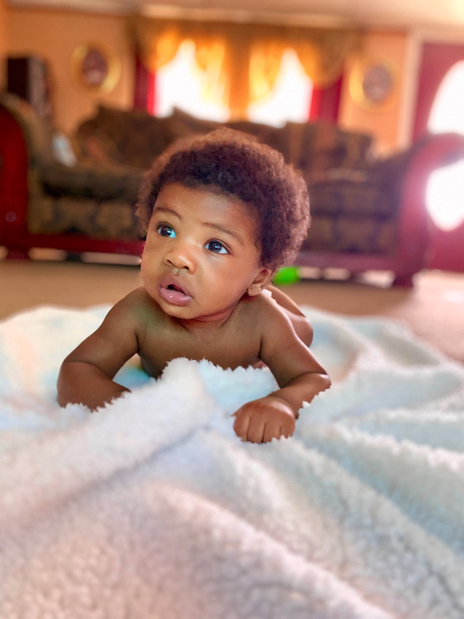 Christian Nolan Wooten is registered to the contest to win money with this photo: baby, beauty, cheek, child, eye, face, fun, happy, head, leisure, person, room, skin, smile, toddler, tummy_time