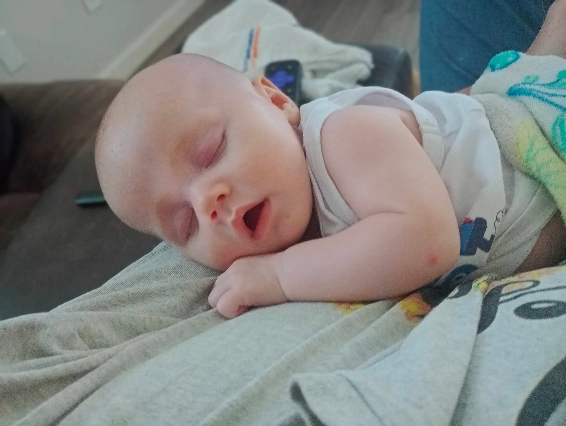 Cleo is registered to the contest to win money with this photo: baby, sleeping, infant, child, person, rest, blanket, arm, clothing, indoors, comfort, peaceful, face, head, skin, mouth, hand, nap, couch, home