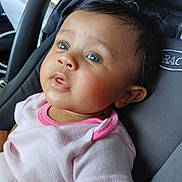 Everly joined the competition — help win amazing prizes! baby, child, blue_eyes, pink_shirt, car_seat, portrait, infant, cute, curious, close_up, young_child, seated, indoors, soft_lighting, black_hair, expression, face, apparel, clothing, person