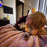 Theo joined the competition — help win amazing prizes! person, cat, glasses, blanket, indoor, cuddle, tabby_cat, bedroom, mirror, door, calendar, plush, fur, hand, watch, cozy, wall, curtain, comfort, love