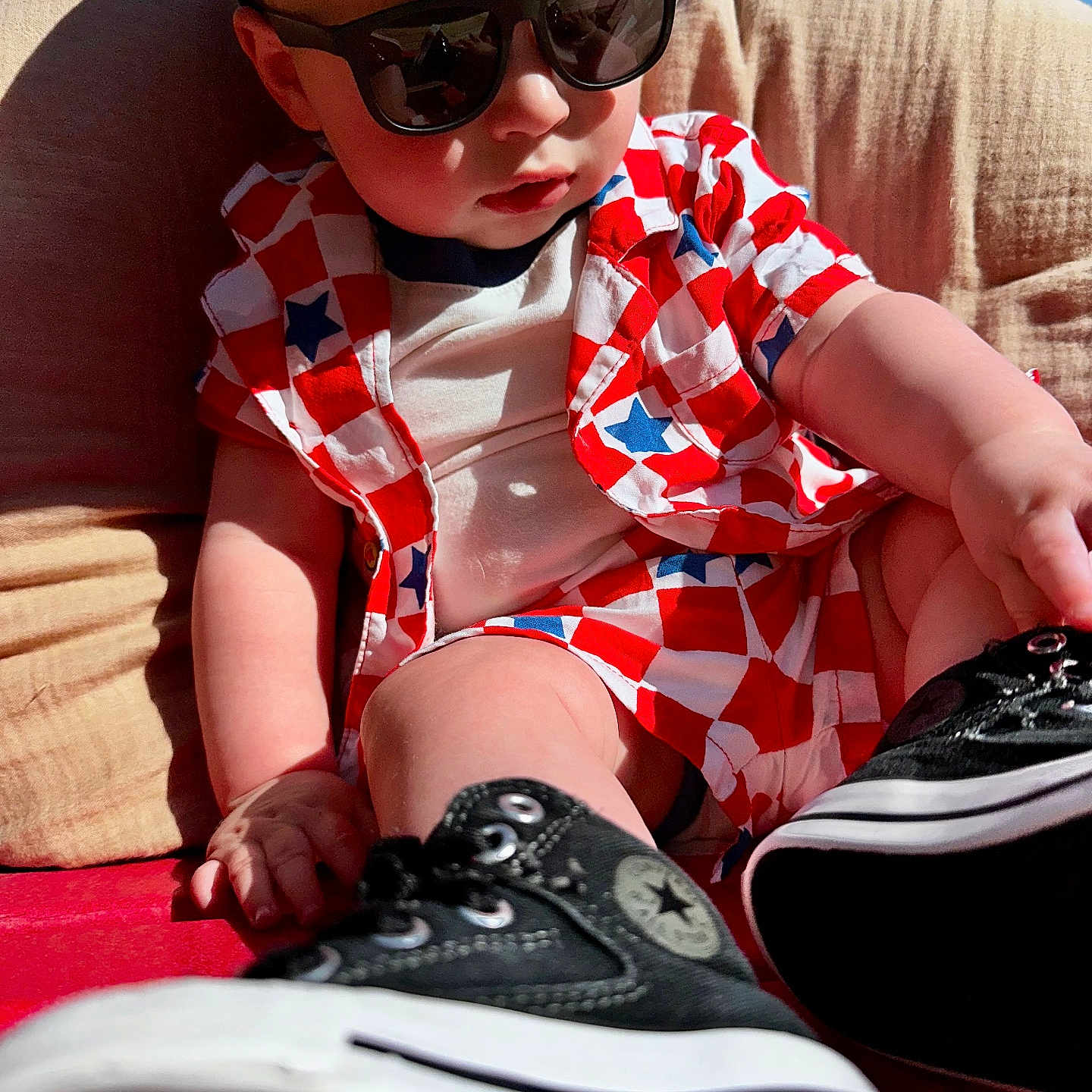 Kace is registered to the contest to win money with this photo: baby, black_sneakers, casual, child, clothing, converse, cute, fashion, footwear, outdoor, red_chair, relaxing, seat, shirt, shorts, star_pattern, summer, sunglasses, sunlight, toddler