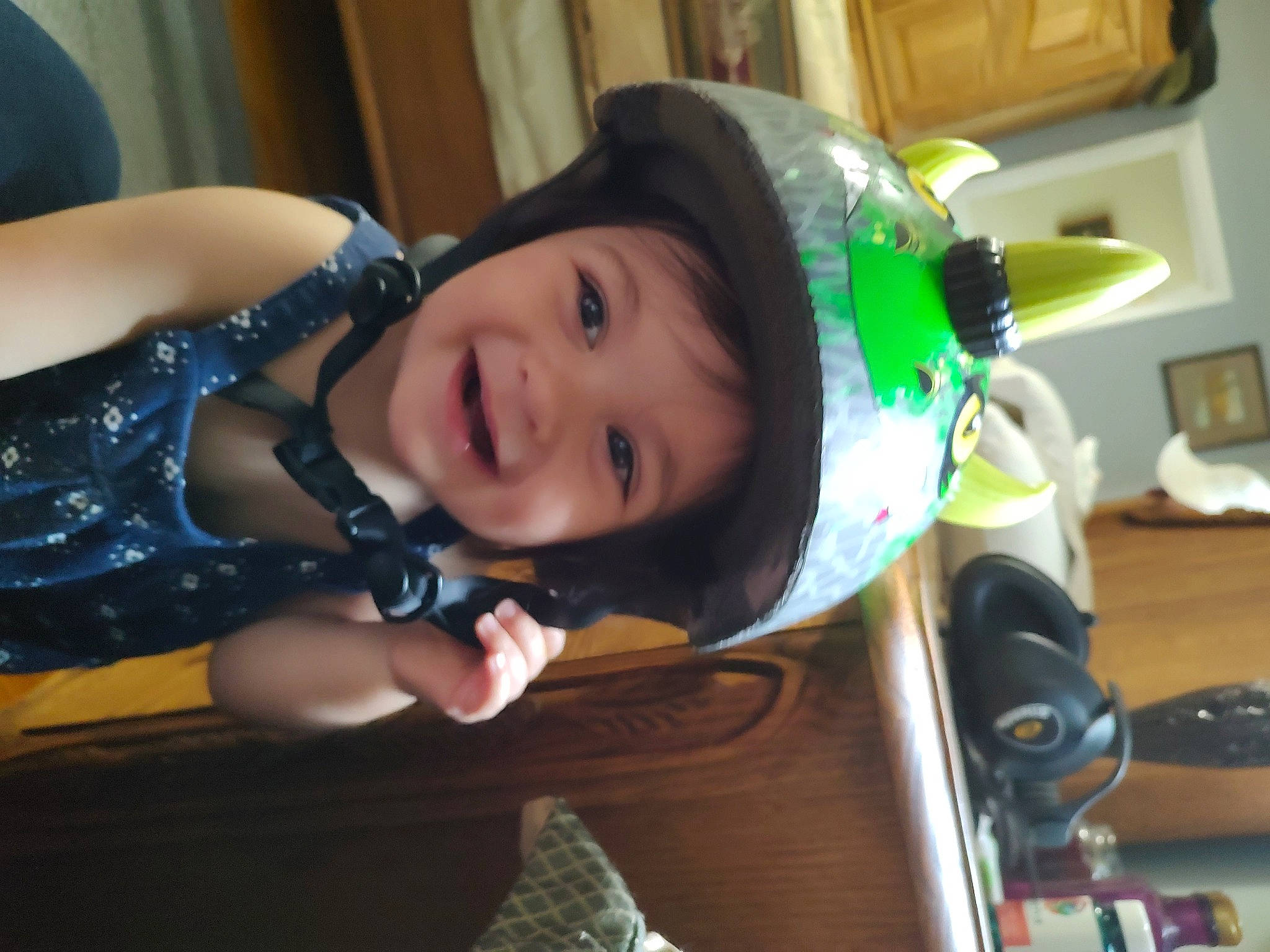 Kimberly joined the competition — help win amazing prizes! audio_equipment, baby, child, costume, event, fun, happy, headwear, helmet, holiday, joy, laugh, leisure, person, personal_protective_equipment, room, sitting, smile, toddler