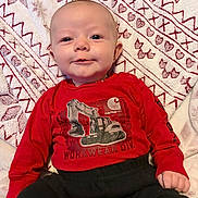 Mark joined the competition — help win amazing prizes! baby, infant, child, portrait, smiling, happy, sitting, lying_down, red_shirt, black_pants, clothing, blanket, patterned_blanket, indoors, close_up, face, eyes, head, construction_graphic, photography