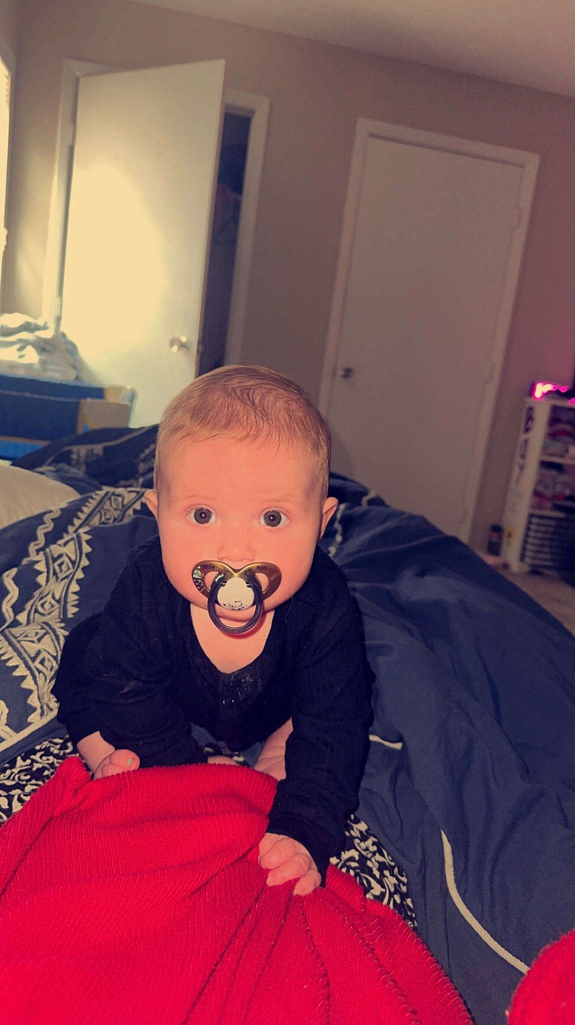 Bayleigh is registered to the contest to win money with this photo: art, baby, baby_toddler_clothing, carmine, child, comfort, door, flooring, fun, happy, headgear, linens, mouth, pattern, person, personal_protective_equipment, room, sitting, sleeve, t_shirt