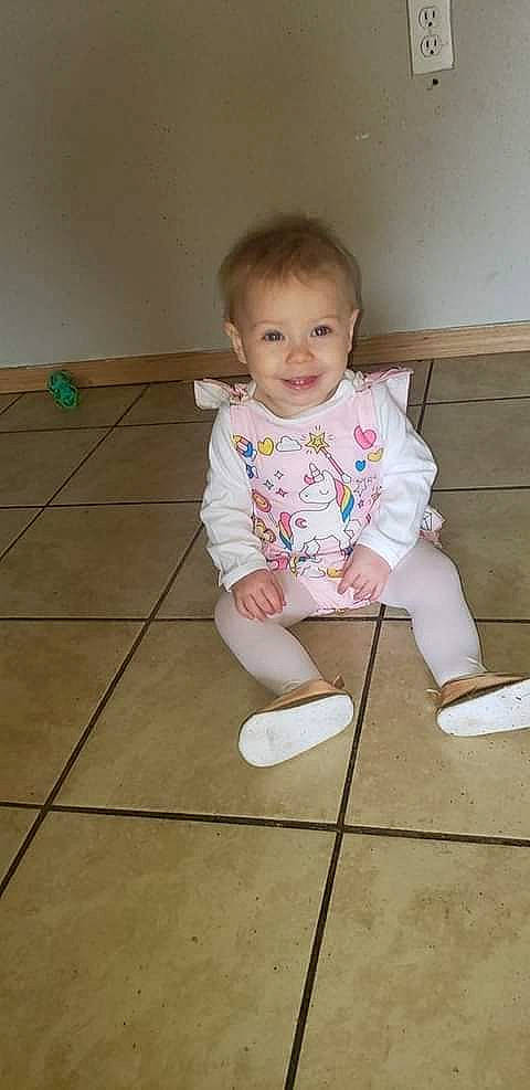 Angel joined the competition — help win amazing prizes! baby, baby_toddler_clothing, cheek, floor, flooring, foot, fun, happy, hardwood, human_leg, iris, joy, knee, person, sitting, skin, sleeve, smile, sock, t_shirt